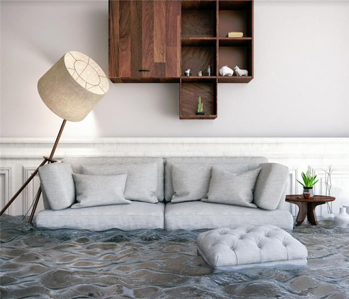 a flooded living room with furniture floating